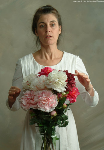 Patricia as Emily Dickinson, with a bouquet of flowers